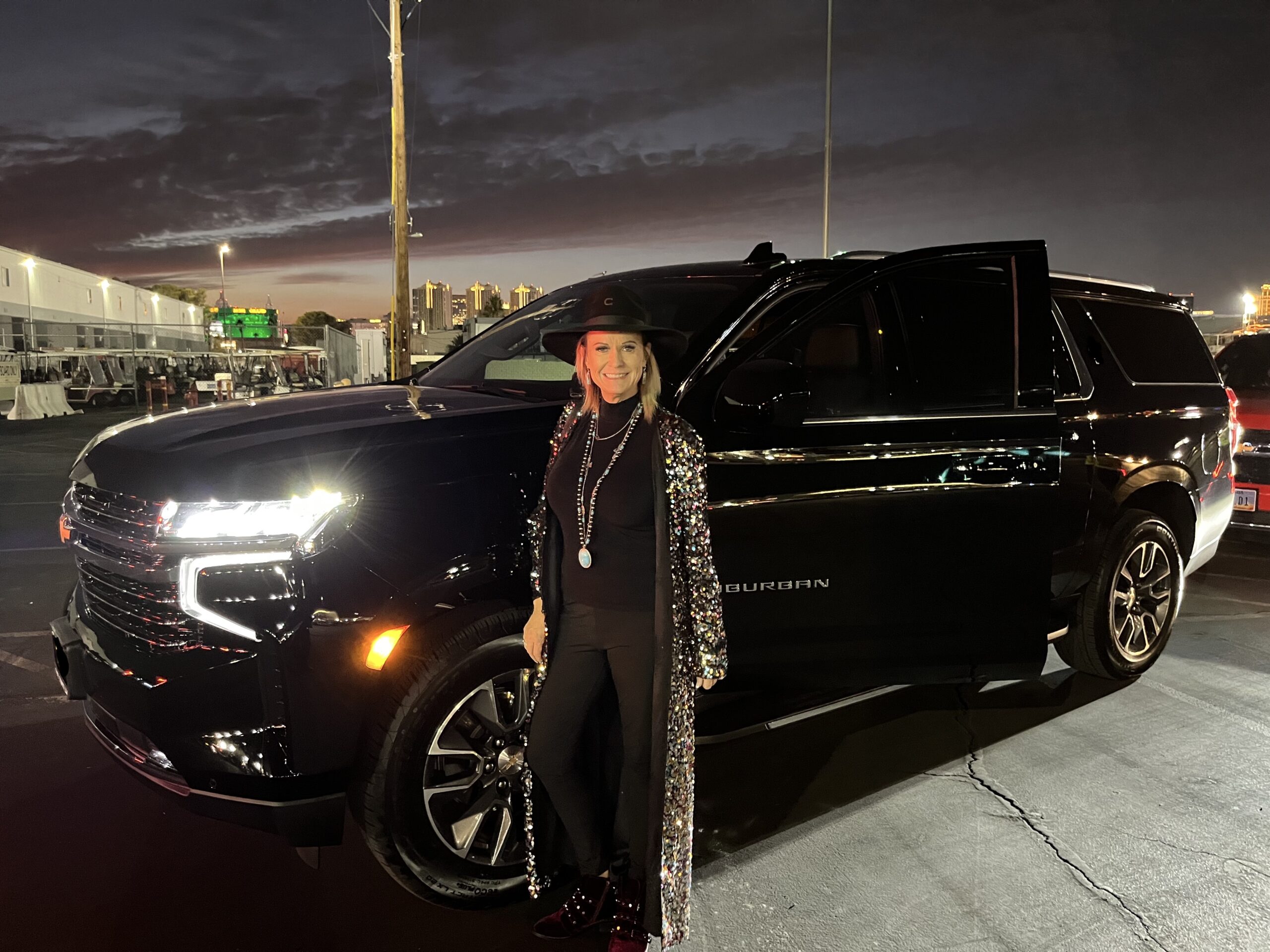 Rodeo lady in front of limo